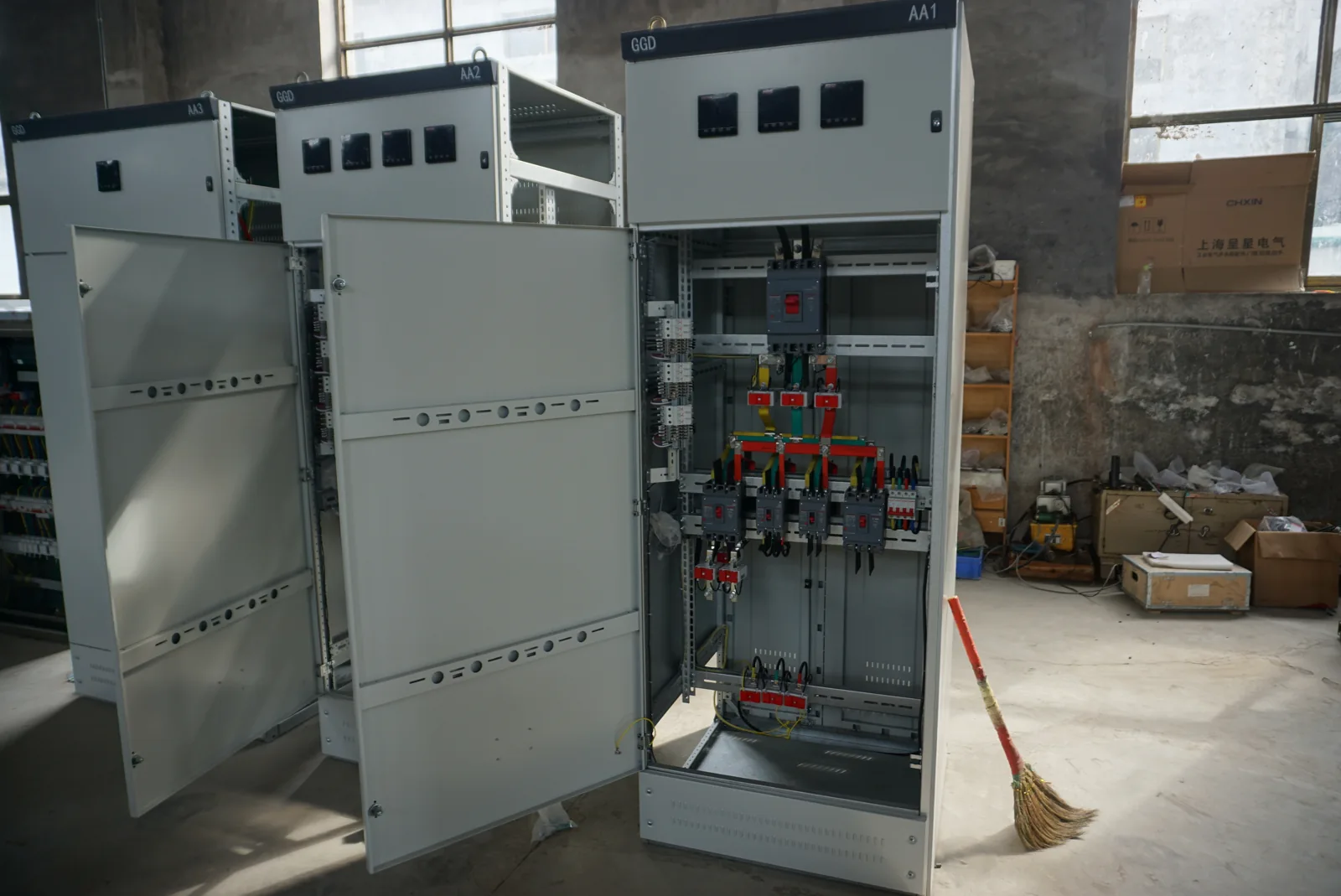 Electrical cabinet assemblies with doors open and internal mounting areas visible